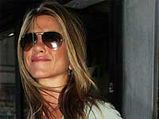 Aniston Does A 'Rolex' To Woo John