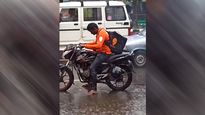 Viral Video: Swiggy Delivery Agent Waits Without Raincoat At Traffic Signal Amid Heavy Rainfall