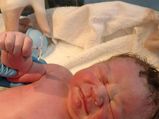 Newborn Holding Mirena IUD Becomes A Star!