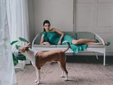 Diana Penty Looks Glam As She Lounges In Her Green Dress While Her Dog Looks Outside The Window
