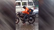 Viral Video: Swiggy Delivery Agent Waits Without Raincoat At Traffic Signal Amid Heavy Rainfall