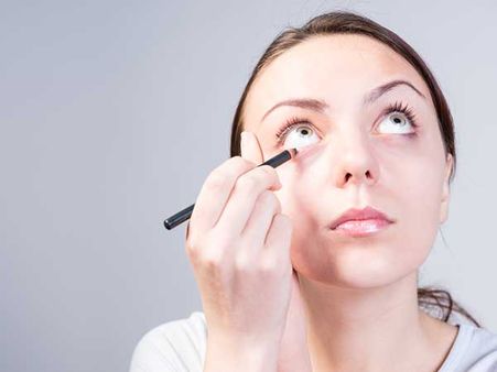 Applying Pencil Eye Liner On The Edge Of The Lower Lid