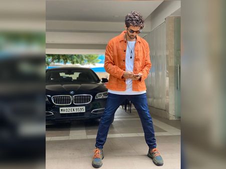 Kartik Aaryan In A White T-shirt, Orange Shirt And Denims
