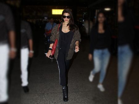 Jacqueline Fernandez In A Black Top, Trousers And Printed Jacket