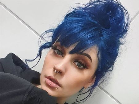 5. Tousled high blue bun with bangs 5. Tousled high blue bun with bangs