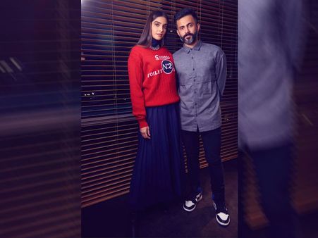 Sonam Kapoor In Red Sweater-Blue Skirt & Anand Ahuja In Blue Attire