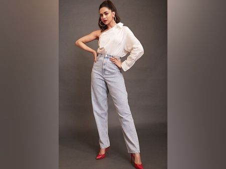 Deepika Padukone In A One-Shoulder White Top And Denim Pants