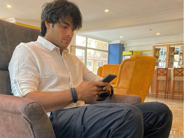 व्हाइट शर्ट और ब्लू पैंट में स्टार एथलीट नीरज चोपड़ा