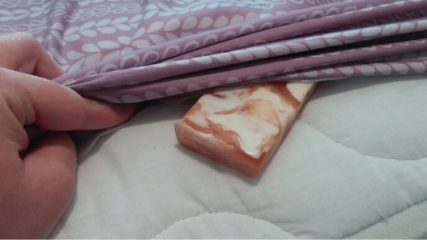 Should you put a bar of soap under your sheets?
