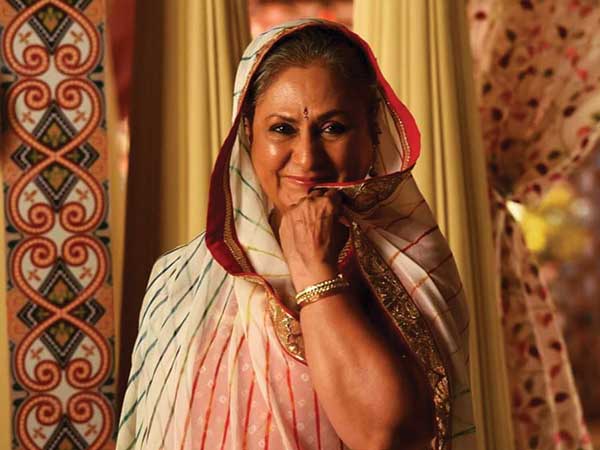 She is sporting a heavy gold necklace and bangles. 