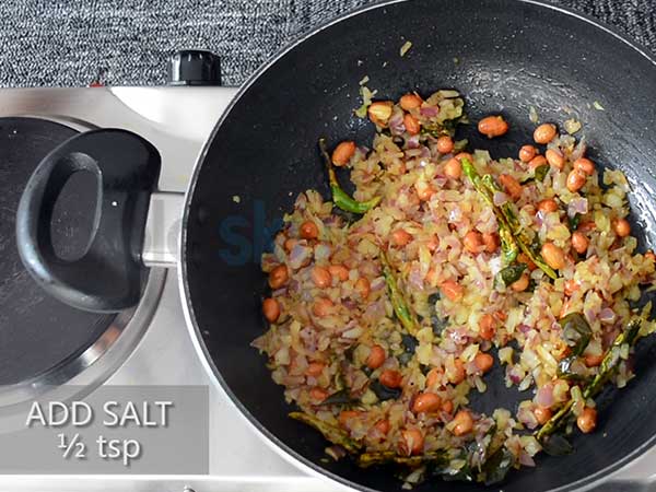 1. Add poha in a large bowl. Add water until the poha is completely immersed. 2. Rinse it thoroughly. 3. Once done, drain the water using a sieve. 4. Add the washed poha in another bowl. 5. Add a bowl of water or a little more than that. 6. Allow it to soak for 10 minutes. Keep it aside. 7. Now, add oil in a heated saucepan. 8. Add mustard seeds and allow it to splutter. 9. Add urad dal and chana dal. 10. Add curry leaves and the slit green chillies. 11. Then, add turmeric powder and stir well. 12. Add the peanuts and stir once more. 13. Sauté for 2 minutes, until the peanuts change its colour. 14. Add the chopped onions and mix well. 15. Add half a teaspoon of salt and mix again. 16. Add the chopped carrots and capsicum. 17. Sauté it for 2 minutes. 18. Further, add the soaked poha by leaving out the water. 19. Mix well, so that the poha blends with all other ingredients. 20. Add half a tablespoon of salt. 21. Add 2 tablespoons of each, chopped coriander leave and grated coconut. Turn off the stove. 22. Finally, add lime juice to get the tangy flavour and mix it one last time. 23. Transfer it into a bowl. 24. Garnish it with coconut and coriander leaves. 25. Serve hot.