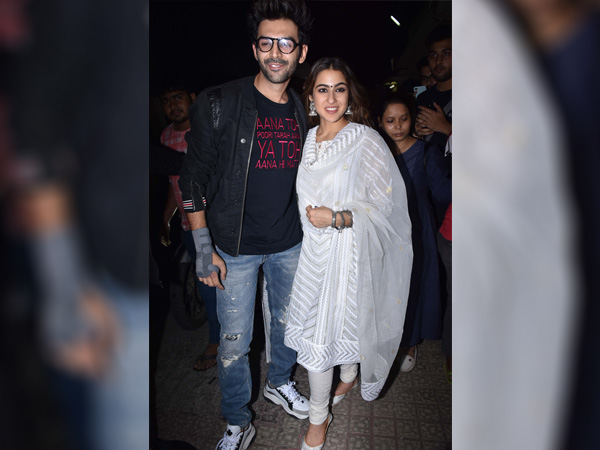 Sara Ali Khan In White Suit & Kartik Aaryan In Black Jacket With Denims