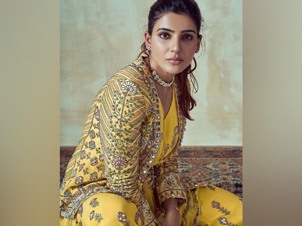 South star Samantha Akkineni is not among the actresses who would have fashion photoshoots every now and then but whenever she has one, she makes sure all eyes are on her. After a long time, recently, the actress treated us with her gorgeous look from her latest photoshoot and shared pictures on her Instagram feed. Dressed in a beautiful yellow ethnic ensemble with intricately embroidered jacket, Samantha exuded diva vibes. So, let us take a close look at her attire and decode it. So, Samantha Akkineni was dressed up in a V-shaped neckline full-length yellow ensemble, which was designed by Arpita Mehta. Her outfit was accentuated by intricate green-hued leaf patterns and white crystal detailing. She layered it with a full-sleeved open-front heavily embroidered matching jacket that featured multi-hued floral patterns and mostly myriad green-hued patterns. The Oh! Baby actress completed her look with a pair of beige-hued heels and accessorised her look with silver-toned studs, a pretty necklace, a bracelet, and a few rings. She painted her nails redto notch up her look. On the makeup front, minimal base marked by sharply contoured and highlighted face and jawline, spruced up her look. Filled thick brows, kohled eyes, heavy mascara, curled lashes, soft blush, and pink lip shade rounded out her look. The Majili actress pulled back her poofy tresses into a neat ponytail and looked elegant. We really liked this yellow ethnic outfit of Samantha Akkineni and it seemed perfect for sangeet functions. What do you think about it? Let us know that in the comment section.
