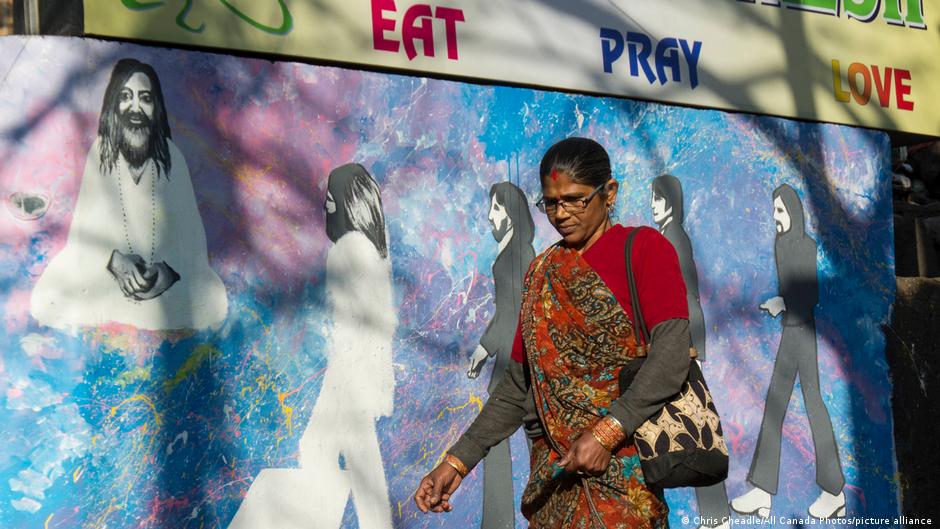 A woman walks on the streets of Rishikesh, a holy town visited by the Beatles