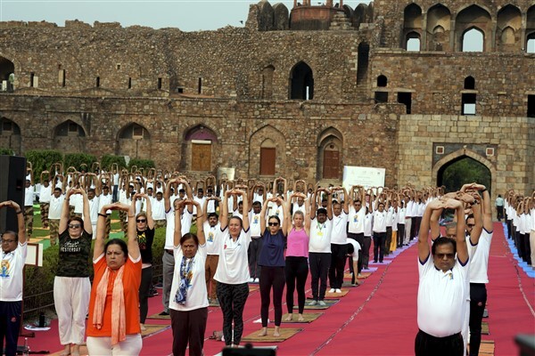 Union Minister of State for External Affairs Meenakashi Lekhi with others performs yoga