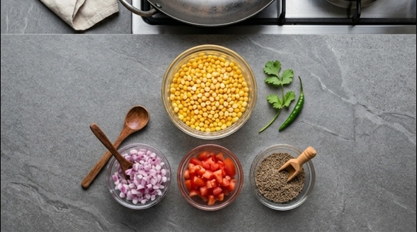 Chana dal boiling in a modern stainless steel pressure cooker with turmeric