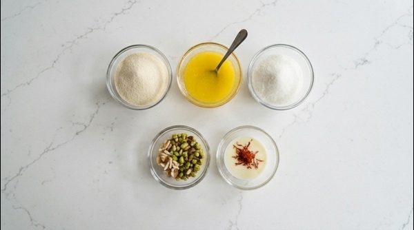 Roasting semolina in ghee inside a modern stainless steel pan