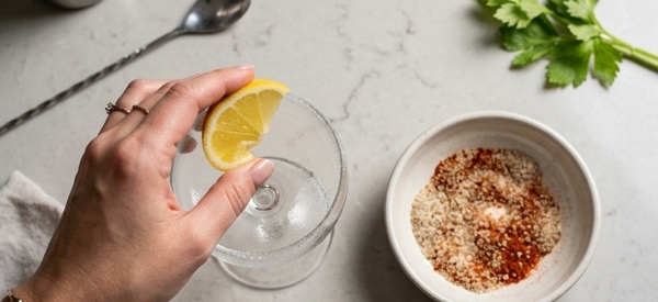 Rimming a cocktail glass with celery salt and spices