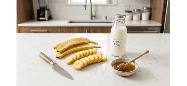 Close up of bananas and milk being blended in a high speed glass blender