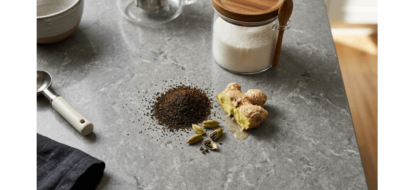 Infusing fresh ginger and cardamom in boiling water for black tea Infusing fresh ginger and cardamom in boiling water for black tea