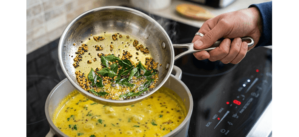 Aromatic tempering being added to the golden Kerala Mor Kulambu