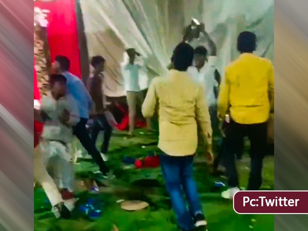 people dancing with plate in marriage hall