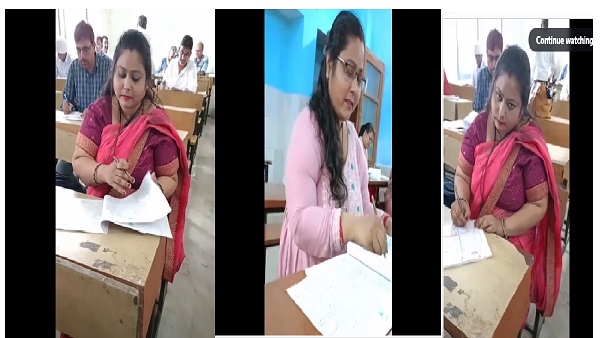 Bihar teacher casually marking answer sheets Bihar teacher casually marking answer sheets
