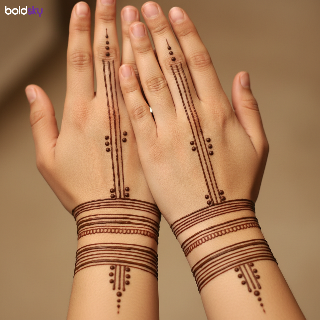 Back of hands with geometric mehndi bands.