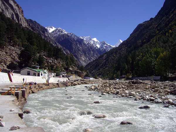 What is the reason behind Indians dropping coins in to holy rivers and praying?