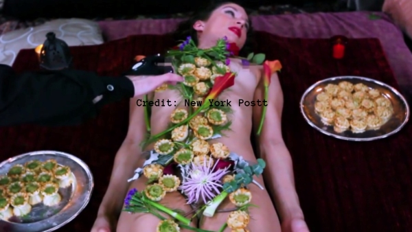 -serving-dinner-to-customers-on-the-body-of-a-naked-